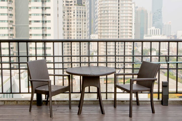 empty-tables-chairs-terrace-with-high-building-view_66869-544